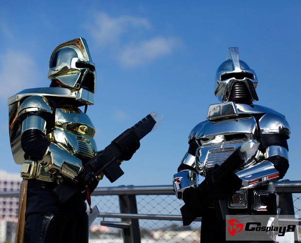 Convention attendees in costume stand on a pedestrian bridge as they leave the convention centre following the opening day of Comic Con in San Diego, California