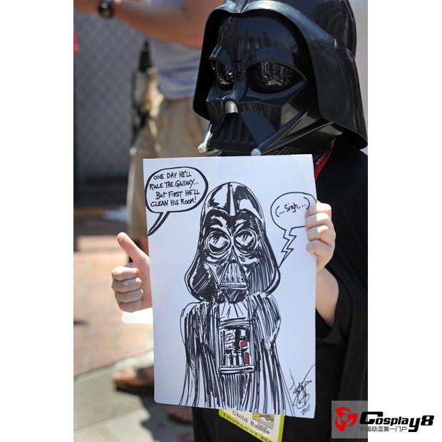 Aiden Best, aged 8, dressed as Darth Vader, give a thumbs up for photographers on the first day of  Comic Con 2011