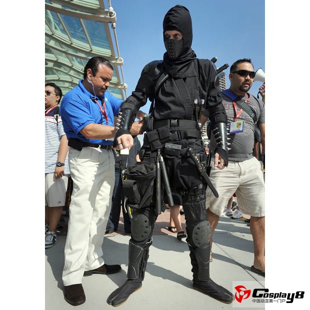 Michael Mason, 27,  dressed as a fully-equipped ninja warrior, has his weapons checked by security