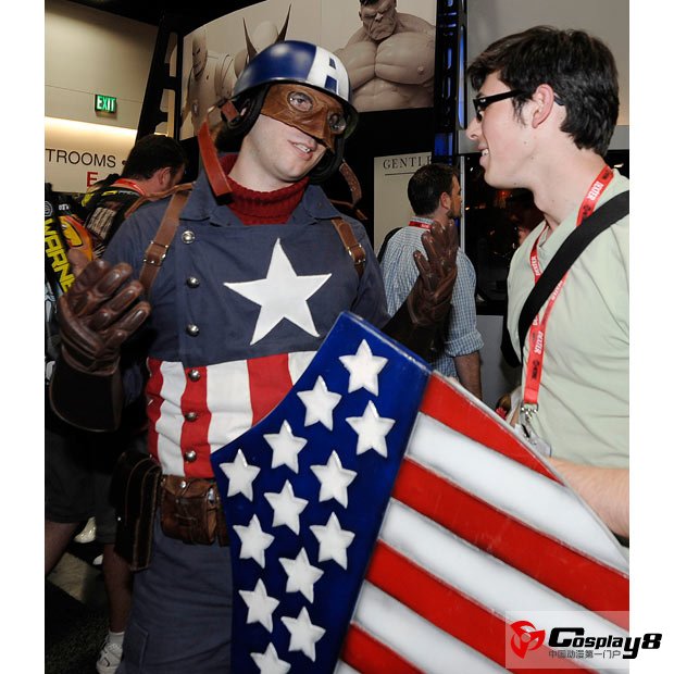 Nathan Paddock, dressed as dressed as Captain America, left, talks with Hadrian Quan at the Comic-Con International 2011 convention held in San Diego