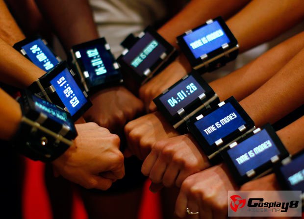 Models pose for a picture wearing wrist watches to promote the upcoming motion picture 'In Time'