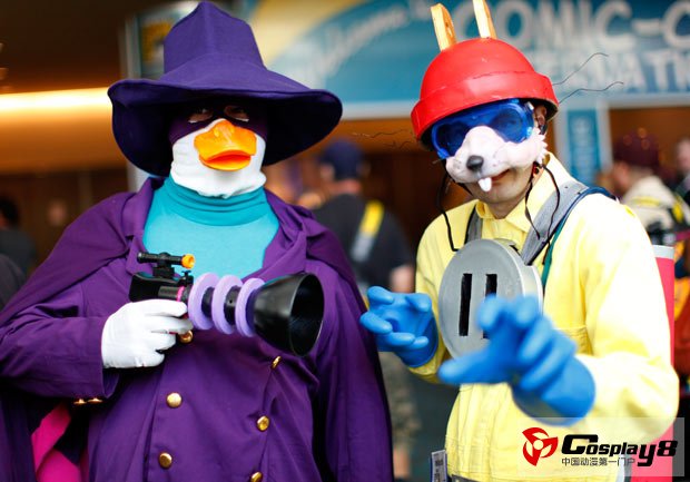 Attendees in costume pose for a picture on the convention floor
